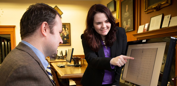 Expert shows researcher record on a computer screen