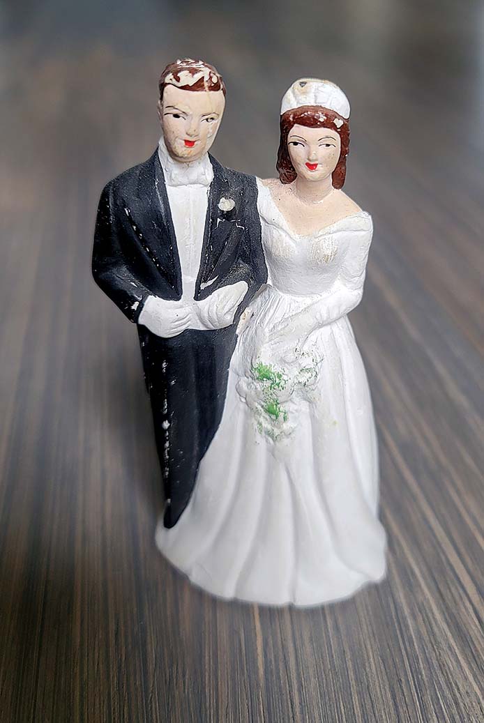 Antique topper for wedding cake shaped like bride and groom