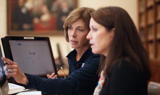 Researcher works with client at a computer