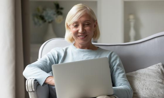 Woman sitting on couch with laptop