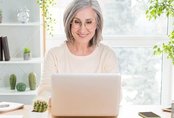 Woman smiling at laptop