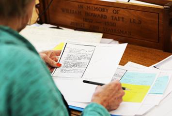 View of papers on desk over shoulder of researcher