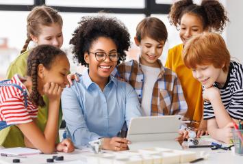 Students gathered around a computer