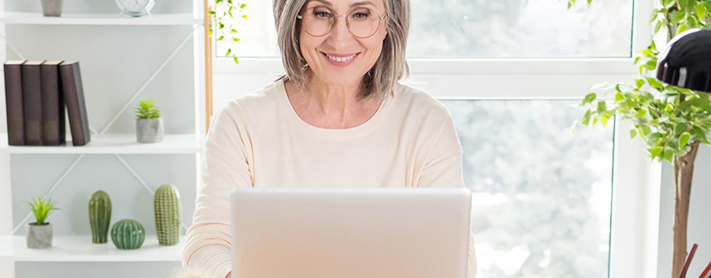 Woman smiling at laptop