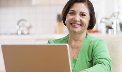 woman with a green shirt on a laptop