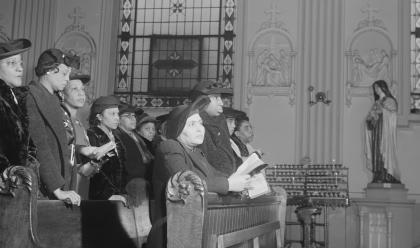 Delano, Jack, photographer. Sunday Mass at Saint Elizabeth's Catholic church. All the pastors here are white with the exception of Father Smith. The congregation is entirely colored. Chicago, Illinois. United States Cook County Illinois Chicago, 1942.