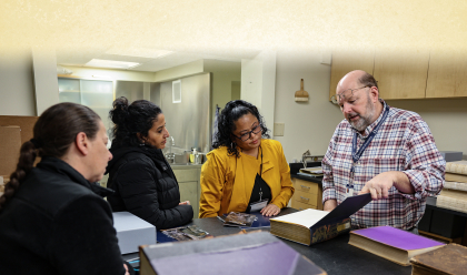 group of people looking at a book