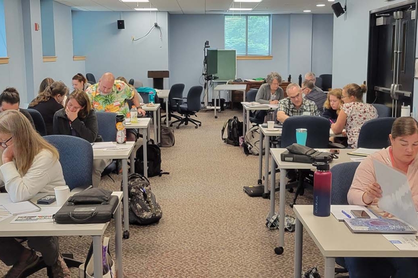 Teachers at tables in a classroom