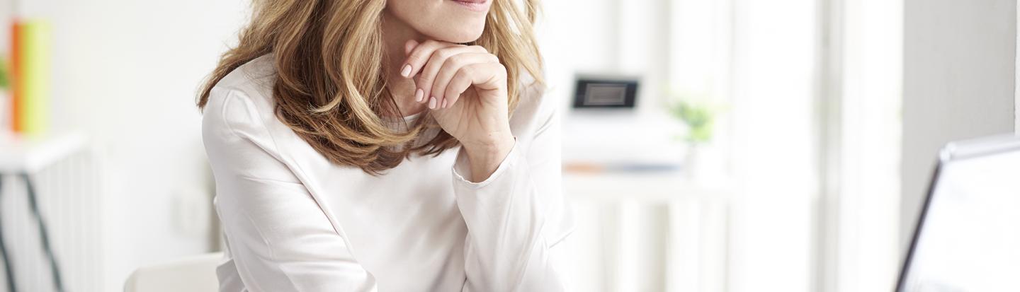 woman on computer with paperwork