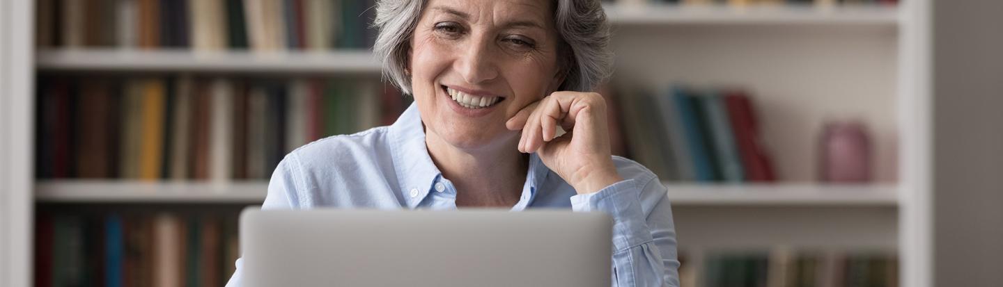woman with blue shirt on laptop