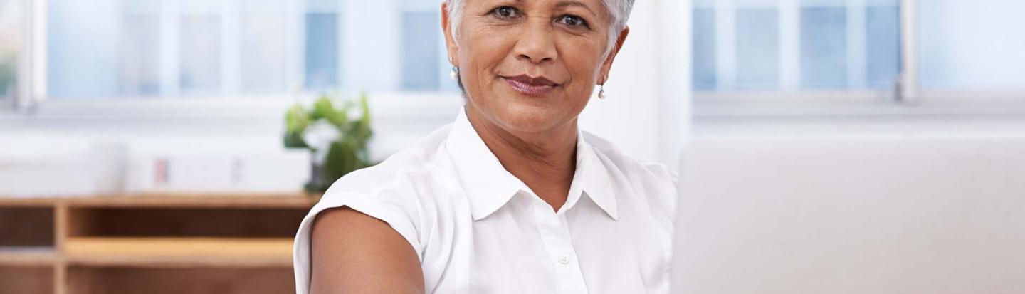 event-whats-new-american-ancestors-12-2022.jpg woman with short hair on laptop