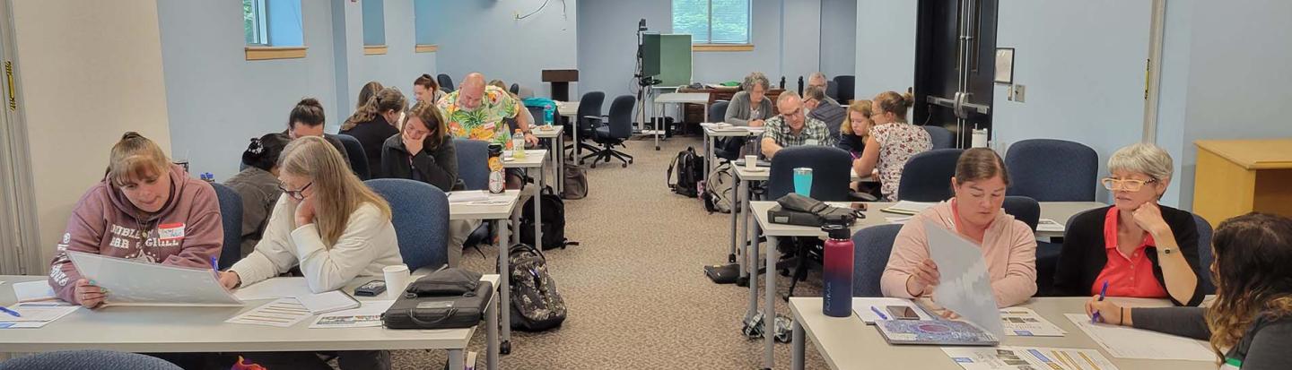 Teachers at tables in a classroom