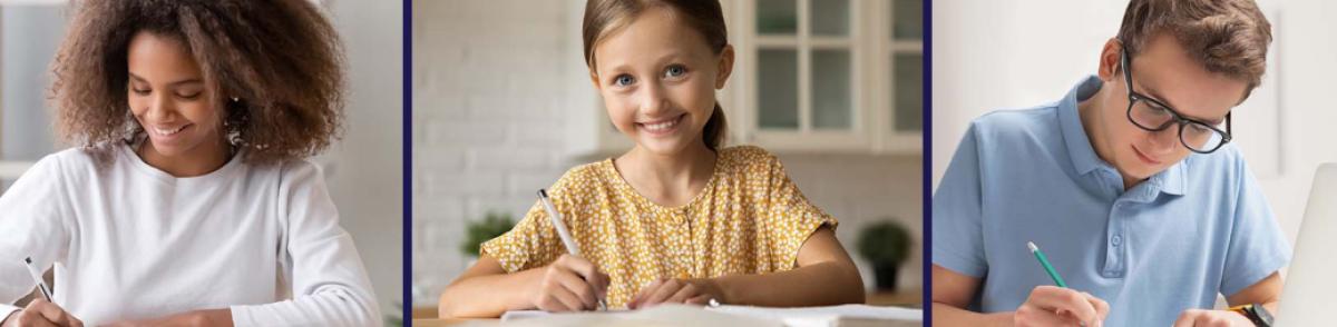 Young students seated at tables writing in notebooks