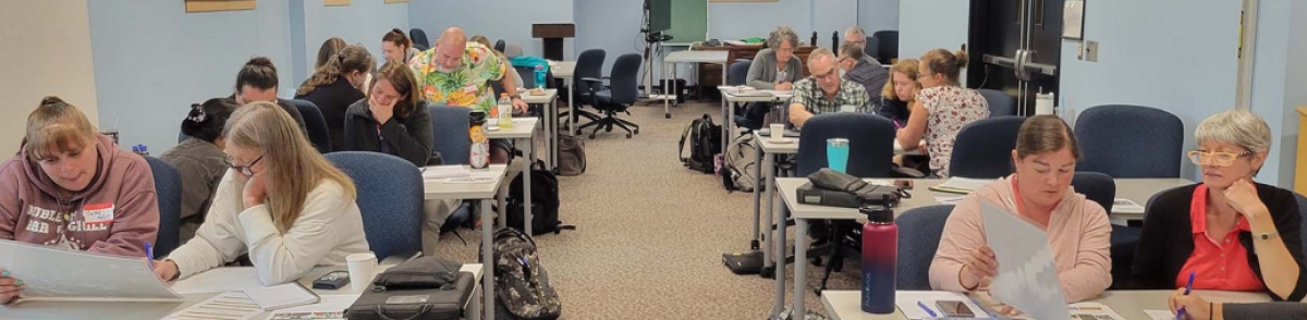 Teachers at tables in a classroom