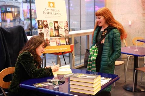 Holly George-Warren signing book for audience member