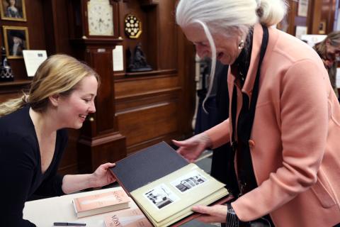 Kristen Richardson looks at picture in book with audience member