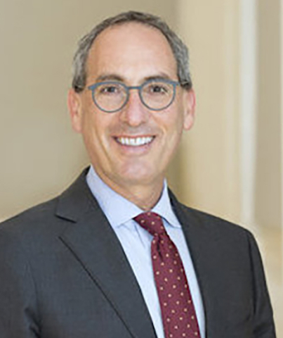 Kevin Tabb, MD: Man in a suit with a red tie with grey hair and glasses.