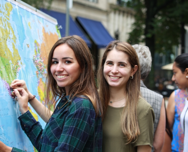 Smiling people pinning location to map