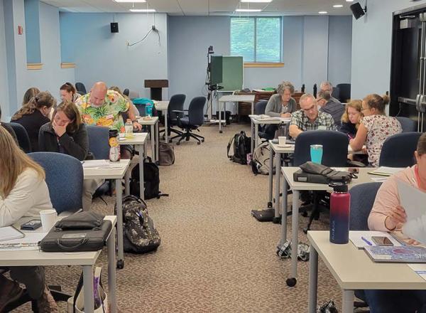 Teachers at tables in a classroom