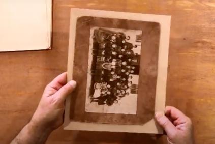 Hands holding an old photograph