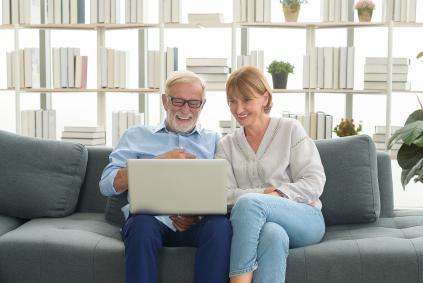 man and woman sitting with laptop