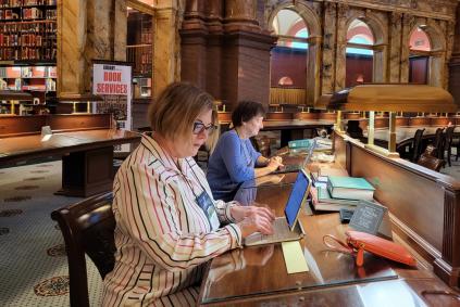 Family history research in a library women doing research in a library