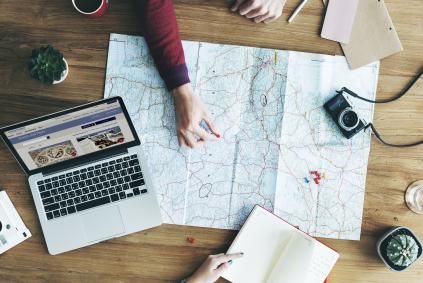 Panel Discussion: Traveling for Genealogy woman putting a pin on a map