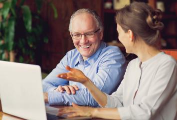 Woman showing a man a computer screen Woman showing a man a computer screen