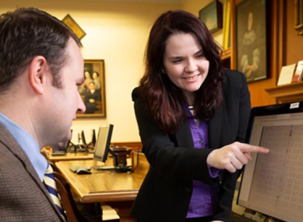 Expert shows researcher record on a computer screen